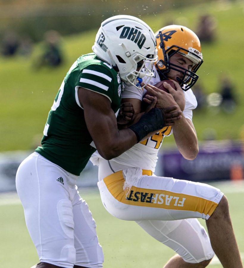 Junior quarterback Dustin Crum is tackled after running the ball during Kent States game at Ohio University on Saturday, Oct. 19, 2019.