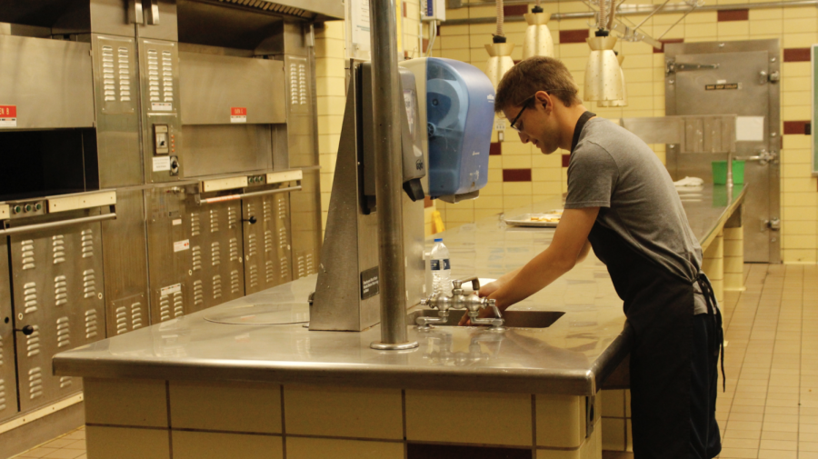 A CCS student prepares for food lab in the Campus Kitchen.