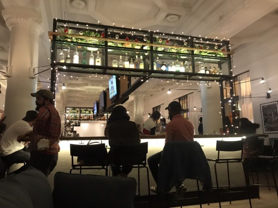 Customers sit at the bar at Sauce in the City.