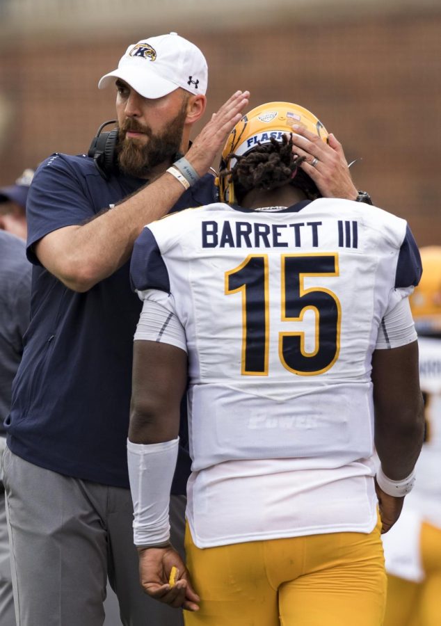 Kent State coach Sean Lewis comforts quarterback Woody Barrett as he walks off the field after he was penalized for unsportsmanlike conduct during a a touchdown celebration in Kent State’s game against Illinois at Memorial Stadium on Saturday, Sept. 1, 2018. The Flashes lost, 31-24.