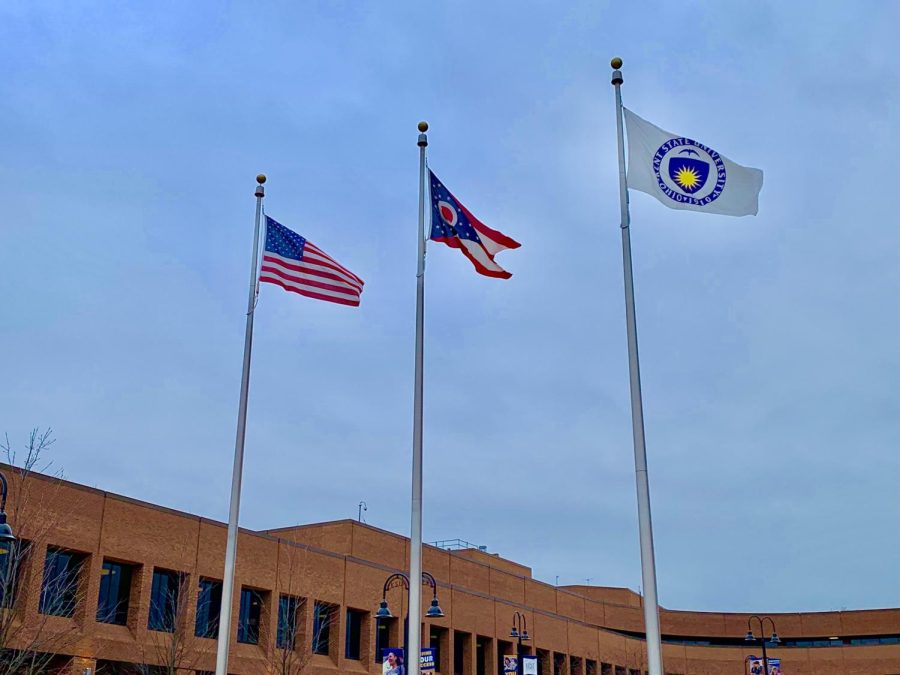 The three flags in the center of campus wave as a reminder of patriotism.