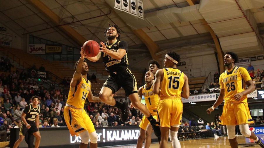 Kent States Tervell Beck (14) tries to block Western Michigan guard Michael Flowers as he cuts to the basket during a Jan. 18 game in Kalamazoo, Michigan.
