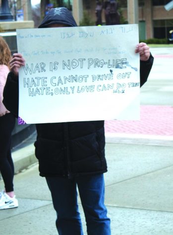 A protestor holds up a sign on Risman Plaza on Jan. 25, 2020. The protest was peaceful and put together by Students for a Democratic Society.