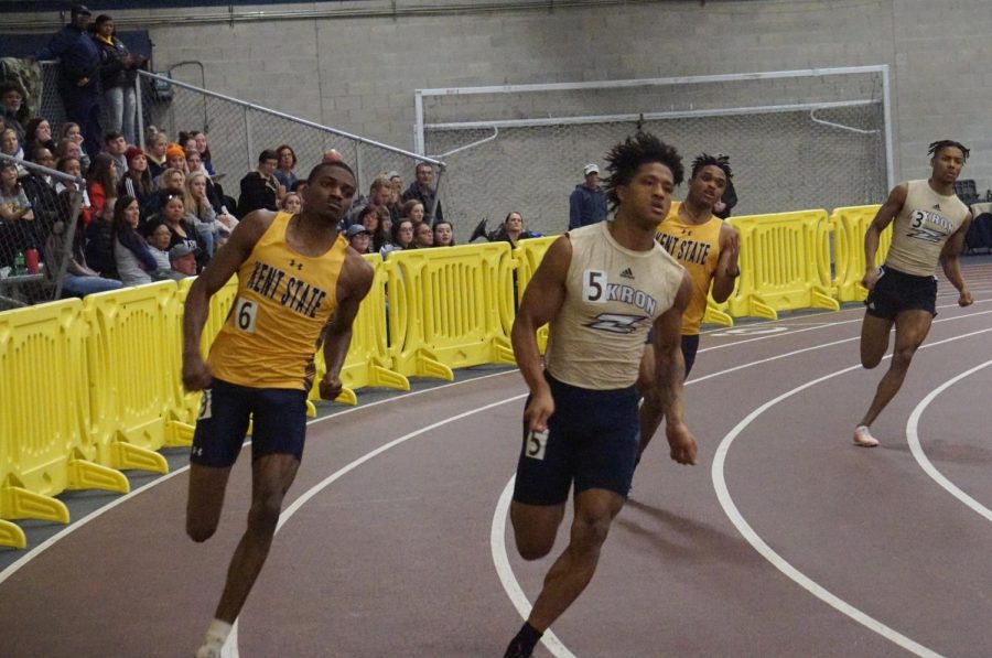 (From left) Sophomore Korie Davis II and Freshman Justin Dwyer compete against Akron during the 400 meter dash at the Kent State Fieldhouse Friday, Jan. 24, 2020. 
