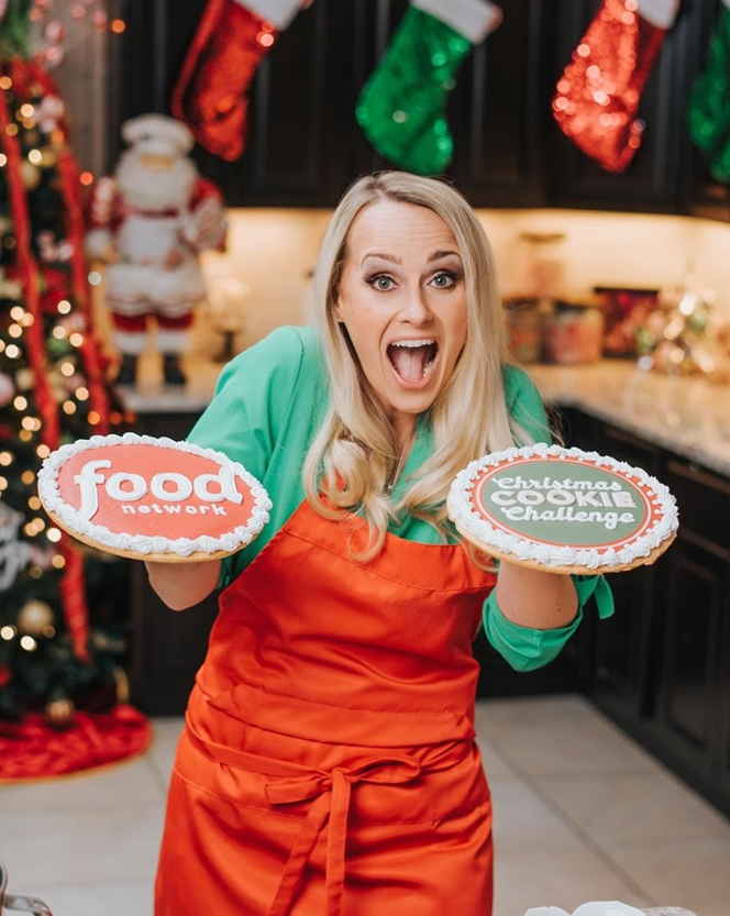 Leslie Srodek-Johnson poses with cookie cakes. Srodek-Johnson won $10,000 on the Food Network Christmas Cookie Challenge. Courtesy of Leslie Srodek-Johnson.