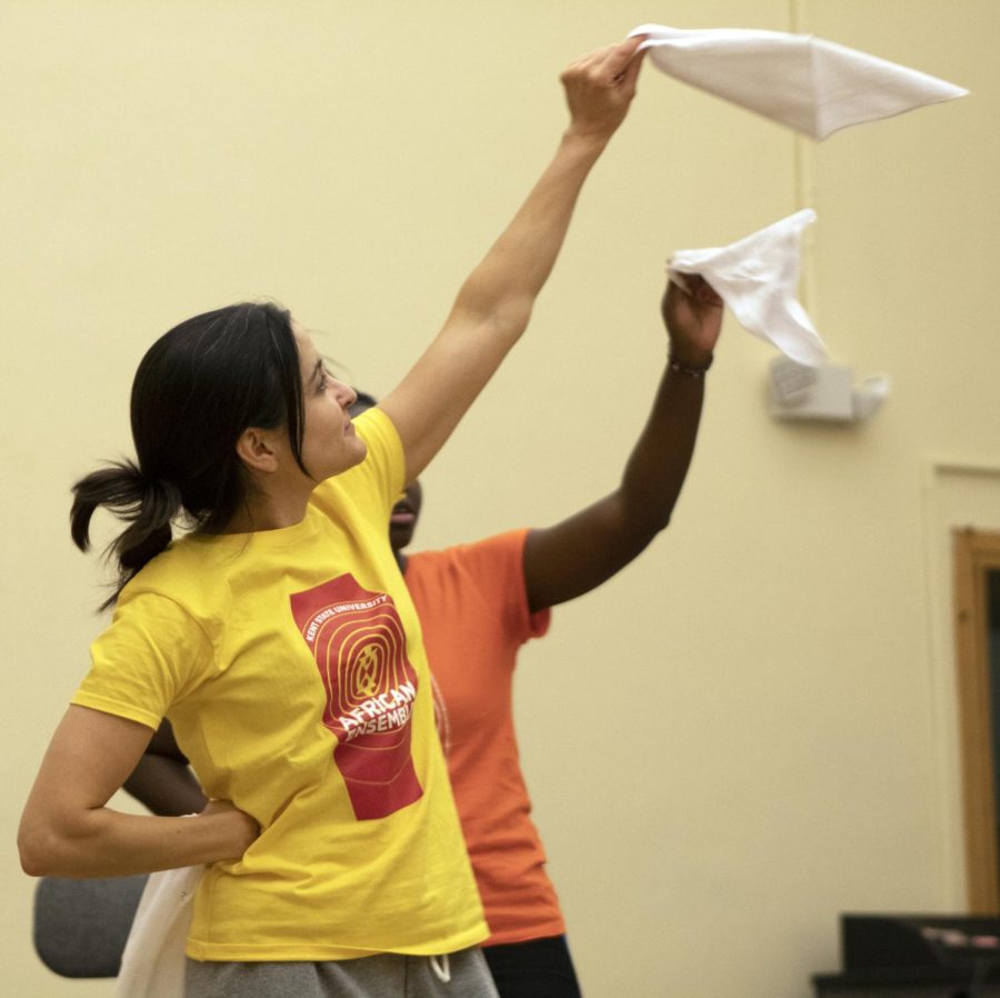 Janine Tiffe, doctor of ethnomusicology and assistant professor, rehearses a dance with the African Ensemble. The dancers waved small towels around to music. Nov. 13, 2019