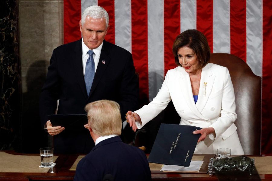 President+Donald+Trump+hands+copies+of+his+speech+to+House+Speaker+Nancy+Pelosi+of+Calif.%2C+and+Vice+President+Mike+Pence+as+he+delivers+his+State+of+the+Union+address+to+a+joint+session+of+Congress+on+Capitol+Hill+in+Washington%2C+Tuesday%2C+Feb.+4%2C+2020.+%28AP+Photo%2FPatrick+Semansky%29