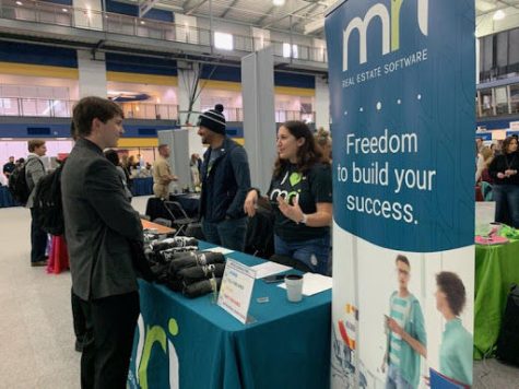 A student talks with a company at the Spring Internship, Co-Op and Career Fair on Feb. 20, 2020. 