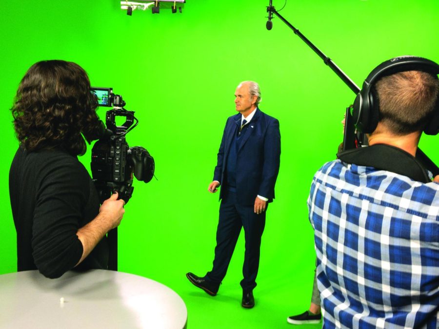 President Todd Diacon tests out the green screen at the TV2 studio on February 13, 2020.