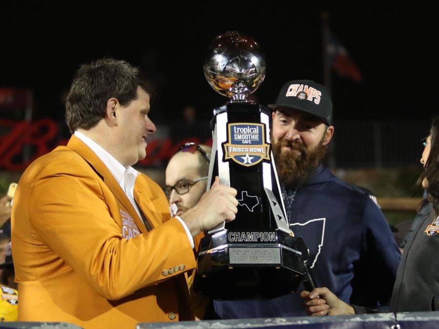 Kent State coach Sean Lewis accepts the Tropical Smoothie Cafe Frisco Bowl trophy after the Flashes beat Utah State 51-41 on Dec 19. 2019.