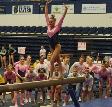 Sophomore Samantha Henry prepares to perform a stunt on the balance beam during the annual pink meet against Bowling Green, the College at Rockport, and Ursinus College at the M.A.C.C. on Friday, Feb. 28, 2020. Kent State won posting its second-highest score of the season at 195.450.