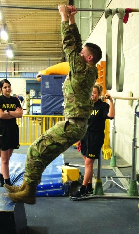 Cadet Kyle Raynard, senior aeronautics major, demonstrates the pull-up portion of the fitness test on February 12, 2020. ROTC members had to do a pull-up, while bringing their legs up and touching their elbows to their thighs.