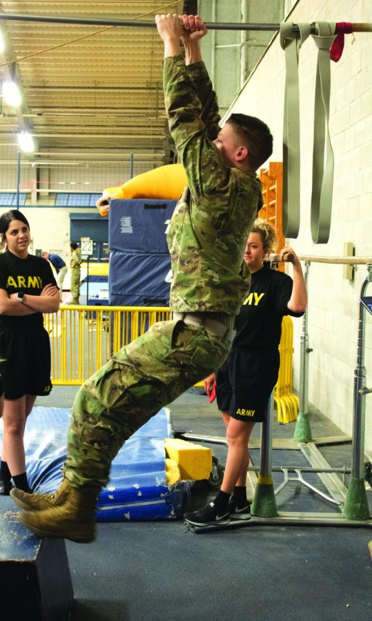 Cadet+Kyle+Raynard%2C+senior+aeronautics+major%2C+demonstrates+the+pull-up+portion+of+the+fitness+test+on+February+12%2C+2020.+ROTC+members+had+to+do+a+pull-up%2C+while+bringing+their+legs+up+and+touching+their+elbows+to+their+thighs.
