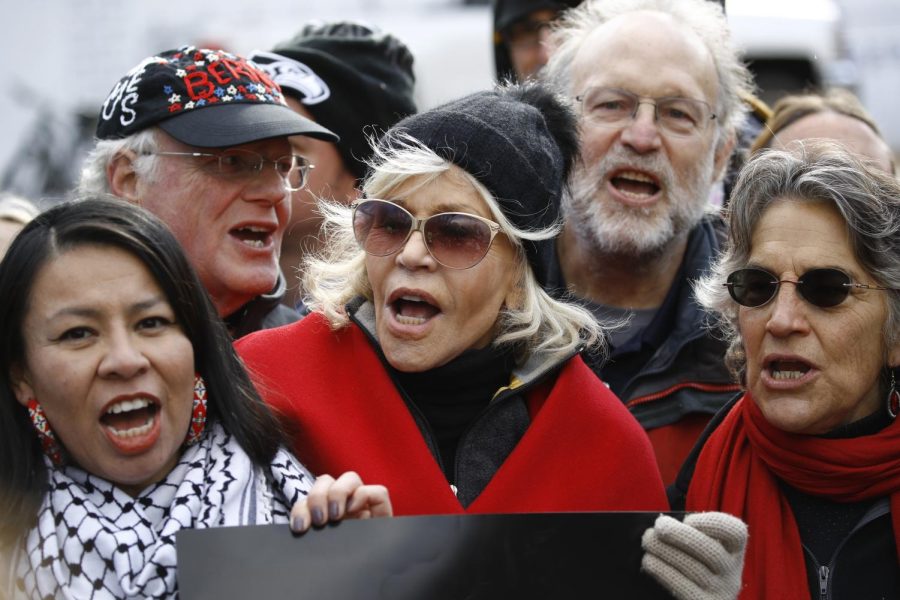 Actress and activist Jane Fonda (center) and others protest against climate policies and advocate for the impeachment of President Donald Trump outside the White House, Nov. 8, 2019, in Washington. Standing behind Fonda are Ben Cohen, left, and Jerry Greenfield, co-founders of Ben and Jerry's ice cream. (AP Photo/Patrick Semansky)