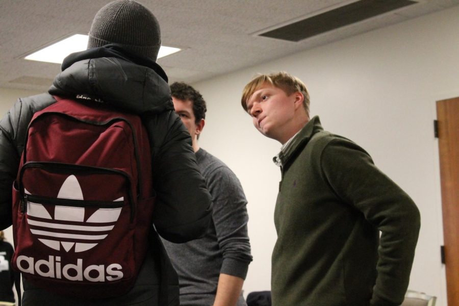 College Democrats president Brandon Hawkins speaks to a student during their meeting/Super Tuesday watch party on March 3, 2020.
