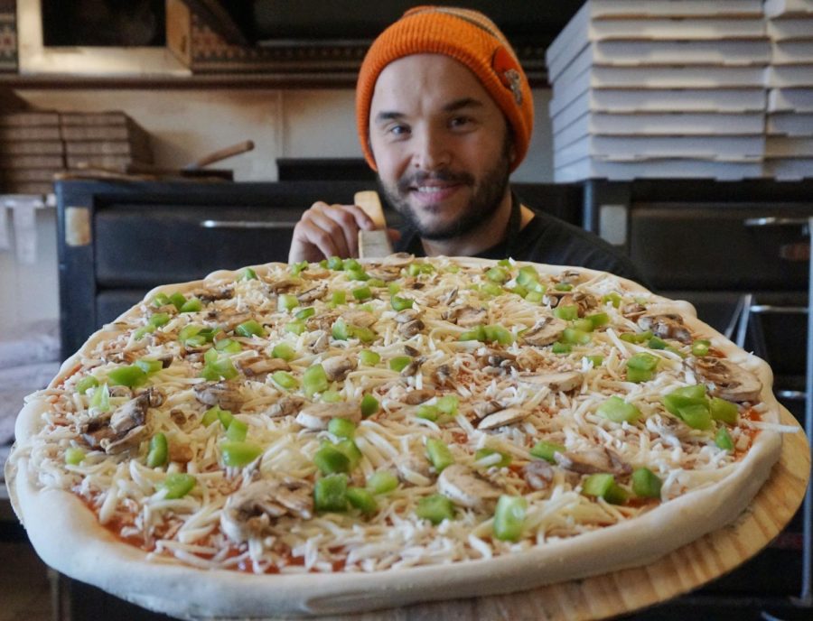 Peter Finley, co-owner of Lucci's Place, holds a pizza that is ready for the oven. Lucci's Place was named #1 for the fourth year in a row for Best of Kent. 