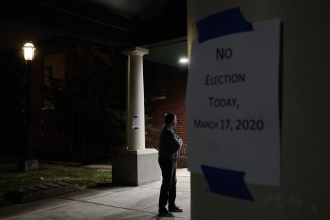 A man, who hoped to vote in the scheduled primary election, stands outside a closed polling station Tuesday, March 17, 2020, at Schiller Recreation Center in Columbus, Ohio. Ohio called off its presidential primary just hours before polls were set to open there and in three other states, an 11th-hour decision the governor said was necessary to prevent further fueling the coronavirus pandemic that has paralyzed the nation. (Joshua A. Bickel/The Columbus Dispatch via AP)