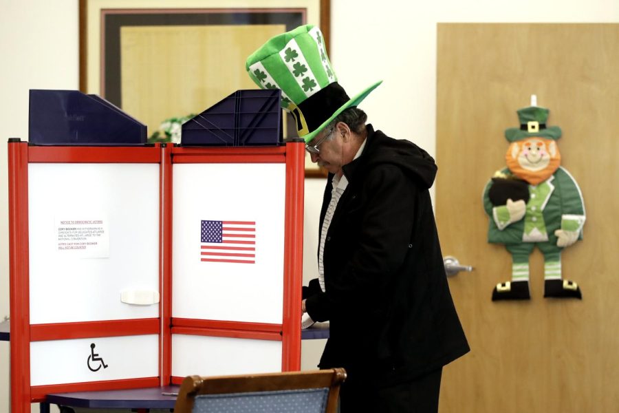 A voter fills out his ballot, taking advantage of early voting, Sunday, March 15, 2020, in Steubenville, Ohio. Elections officials in the four states, Arizona, Florida, Illinois and Ohio, holding presidential primaries next week say they have no plans to postpone voting amid widespread disruptions caused by the coronavirus outbreak. Instead, they are taking extraordinary steps to ensure that voters can cast ballots and polling places are clean. (AP Photo/Gene J. Puskar)