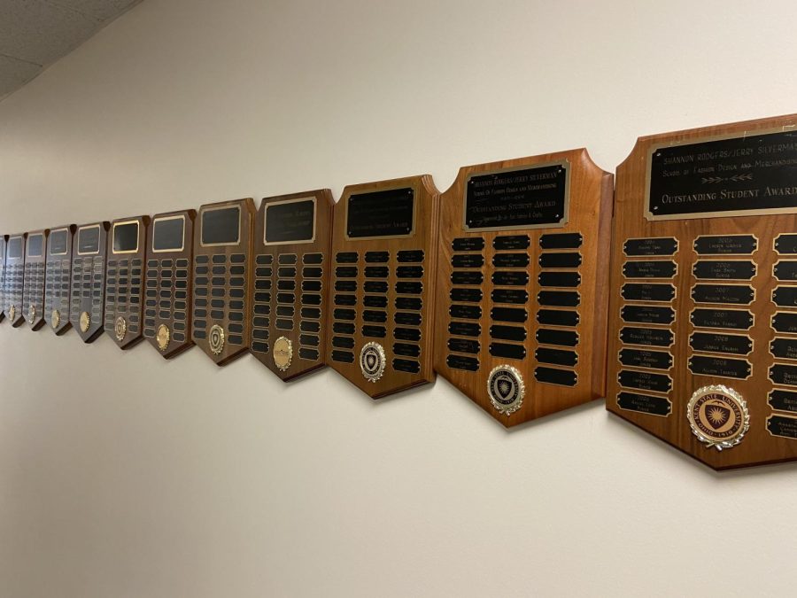 Plaques with all the donors of scholarship’s names hang on the second floor of Rockwell Hall, the fashion building.