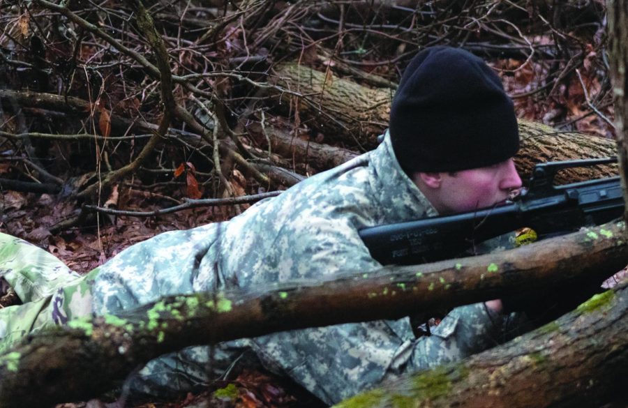Sophomore construction management major John Moes watches the perimeter during the ROTC’s tactics portion on Feb. 26, 2020. The mission took place in the woods next to Allerton Field and the plan was to conduct an attack.