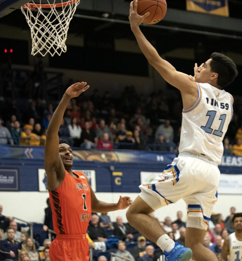 Freshman Giovanni Santiago [11] makes a layup to give Kent State a 65-50 against Bowling Green on Mar. 3, 2020. Santiago scored six points on 3-for-3 shooting in 23 minutes. Kent State won 83-69. 