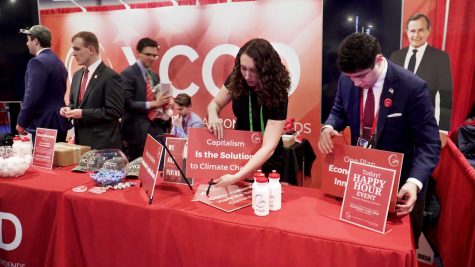 Kiera OBrien, center, a senior at Harvard, and colleagues set up the Young Conservatives for Carbon Dividends stand at the 2020 Conservative Political Action Conference on March 6, 2020.