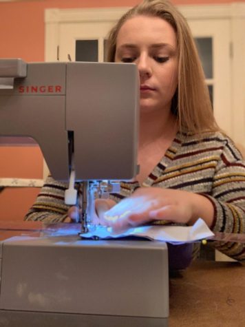 Alyssa Hertz, junior fashion design major, works at her sewing machine creating masks to donate to hospitals in need. 