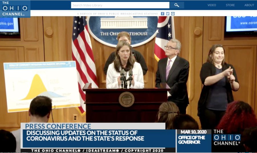 Dr. Amy Acton, Ohio Department of Health Director, center, discusses the states response to the coronavirus outbreak, as Gov. Mike DeWine, right, studies an update on the cases on Tuesday, March 10, 2020, in Columbus, Ohio. Acton said DeWine was leaning in and being aggressive in taking precautions against the disease. 