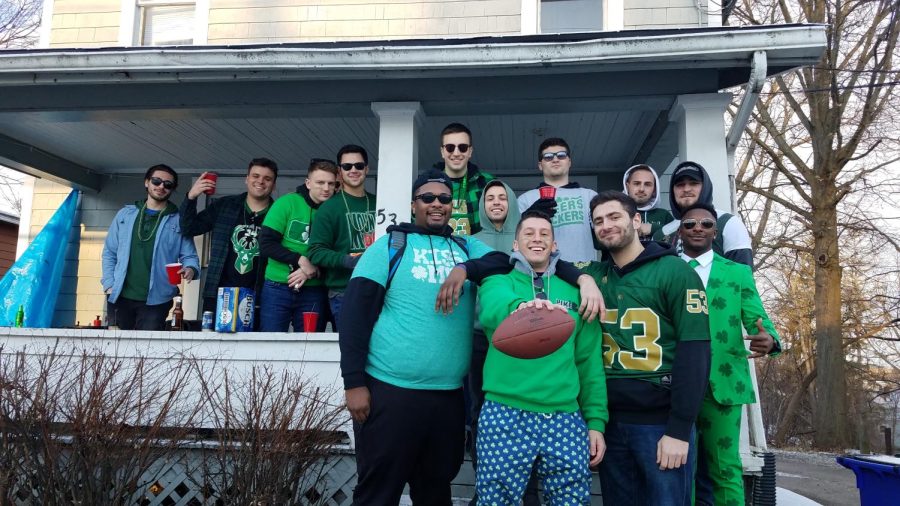 A group poses for a photo after tossing around a football in Kent, Ohio, on Summit Street, March 16, 2019. Editors Note: Everybody in this photo is over 21. 