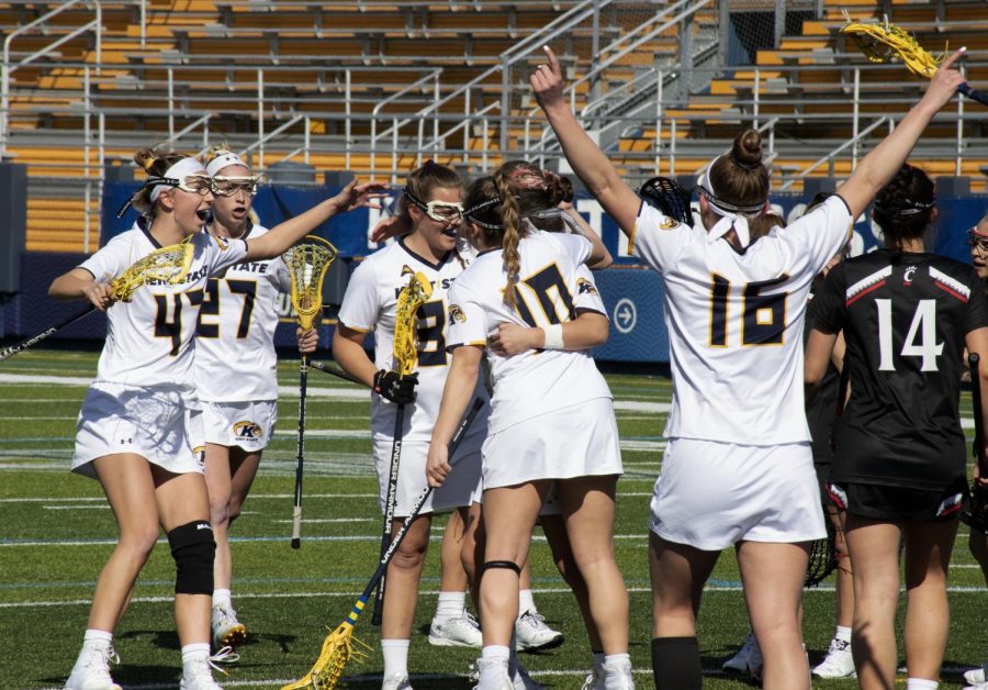 Members of the Kent State University women’s lacrosse team celebrate a point during their game on Mar. 8, 2020 against University of Cincinnati. Kent State University lost 8-25.