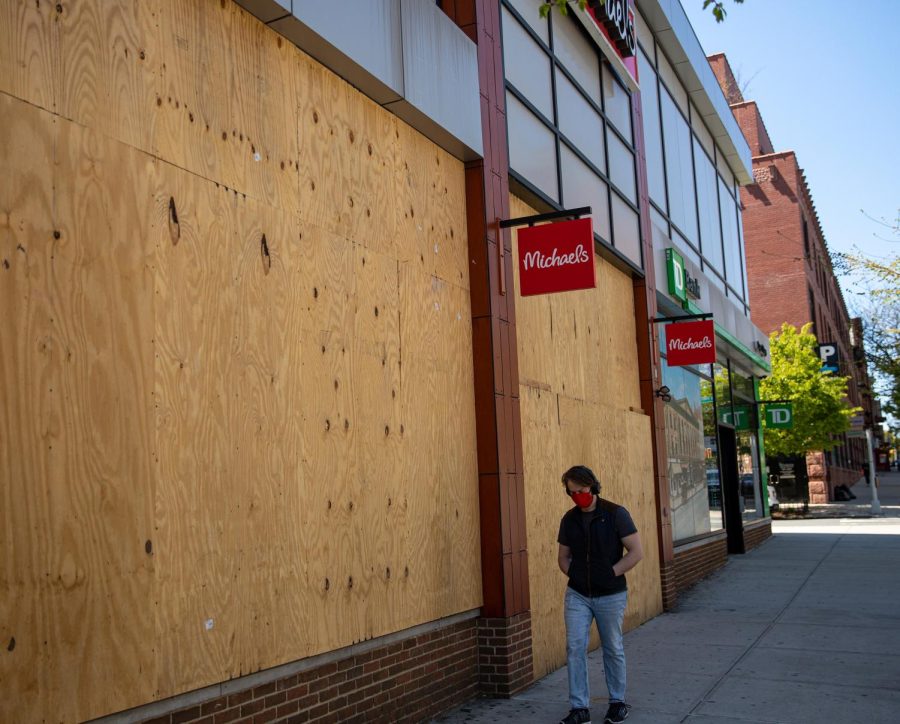 NEW YORK, NY - APRIL 28: A man walks past a closed and boarded up Michaels retail store on April 28, 2020, in the Brooklyn borough of New York City. Michaels, based in Dallas, Texas, sells arts and crafts merchandise. The World Health Organization declared coronavirus (COVID-19) a global pandemic on March 11th. (Photo by Robert Nickelsberg/Getty Images)