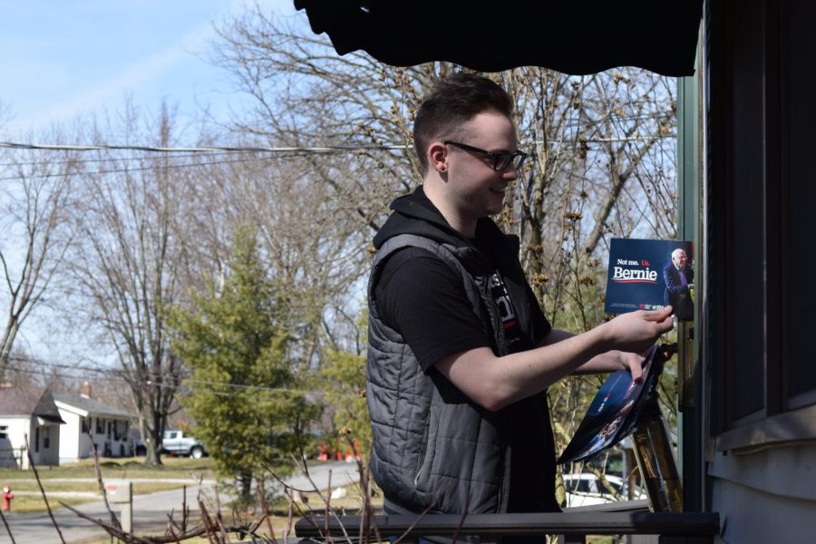 President of Kent State for Bernie 2020 Adam Schroeder hands out a flyer during their “Knock for Bernie” event on March 8, 2020.