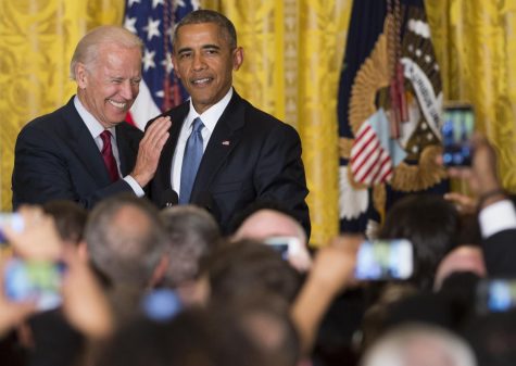 US President Barack Obama and US Vice President Joe Biden attend a reception in honor of LGBT Pride Month in the East Room of the White House in Washington, DC, June 24, 2015. AFP PHOTO / SAUL LOEB (Photo credit should read SAUL LOEB/AFP/Getty Images)