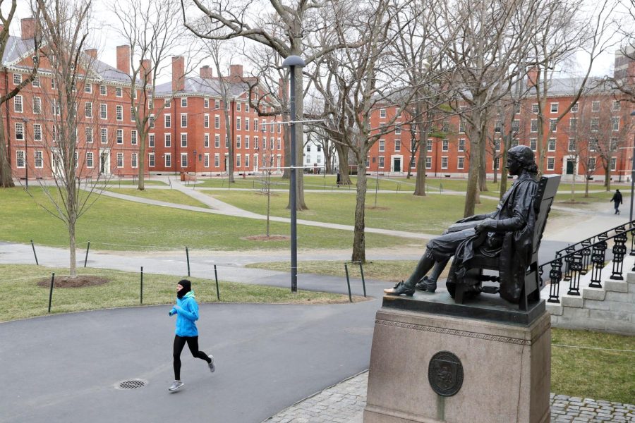 CAMBRIDGE, MASSACHUSETTS - MARCH 23: A runner crosses Harvard Yard on March 23, 2020 in Cambridge, Massachusetts. Students were required to be out of their dorms no later than March 15 and will finish the rest of the semester online due to the ongoing COVID-19 pandemic. (Photo by Maddie Meyer/Getty Images)