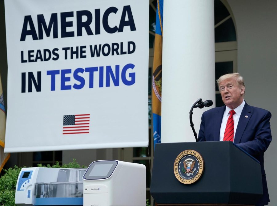U.S.+President+Donald+Trump%2C+flanked+by+tables+holding+testing+supplies+and+machines%2C+speaks+during+a+press+briefing+about+coronavirus+testing+in+the+Rose+Garden+of+the+White+House.