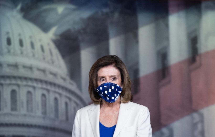 Speaker+of+the+House+Nancy+Pelosi+wears+a+mask+to+protect+herself+and+others+from+COVID-19%2C+known+as+coronavirus%2C+as+she+arrives+to+hold+her+weekly+press+conference+on+Capitol+Hill+in+Washington%2C+DC%2C+April+30%2C+2020.