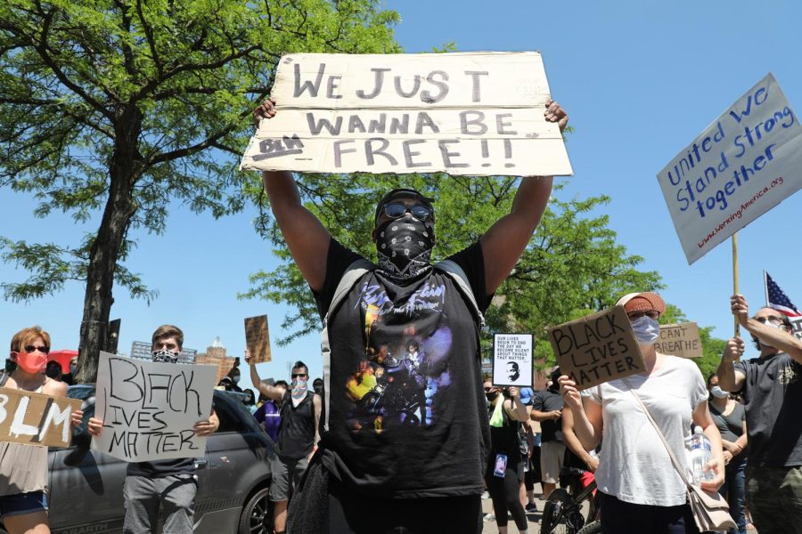 Chad+Payne+of+Akron+holds+up+a+sign+as+he+stands+in+the+middle+of+S.+High+St.+in+downtown+Akron+during+a+protest+march+to+end+police+brutality+on+June+6%2C+2020.