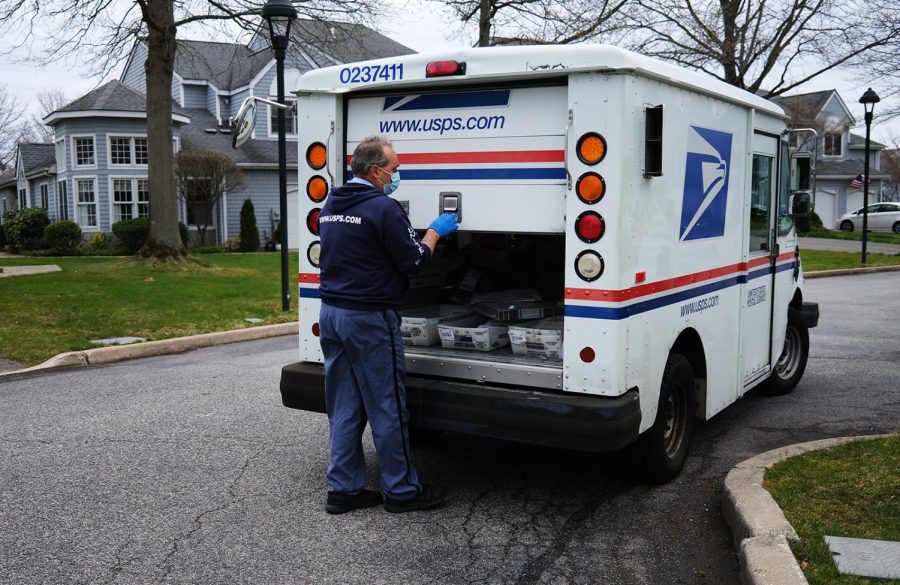 The+US+Postal+Service+%28USPS%29+is+warning+states+that+voters+risk+not+getting+their+ballots+back+to+election+offices+in+time+because+of+lags+in+mail+delivery.+This+image+shows+a+USPS+worker+doing+his+daily+delivery+route+on+April+15%2C+in+New+York.