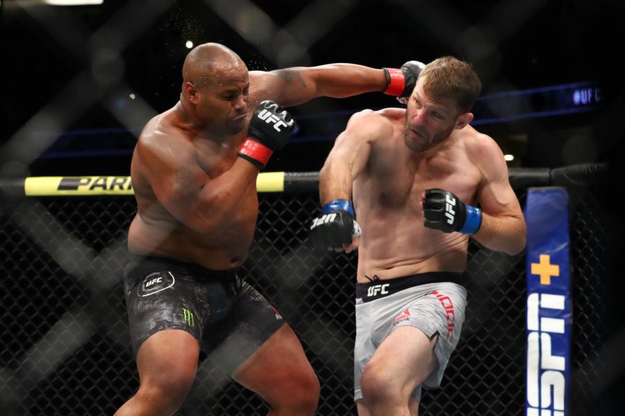 Cormier+throws+a+punch+at+Miocic+in+the+first+round+during+their+UFC+heavyweight+bout+in+2019.