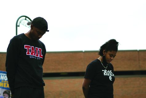 Senior finance major Cameran Cunningham (left) and junior history major Gabrielle Blake (right) hold a moment of silence for 9/11 during the Black Lives Matter protest on Sept. 11, 2020. Cunningham is a member of Kappa Alpha Psi, the first all-Black fraternity at Kent State.