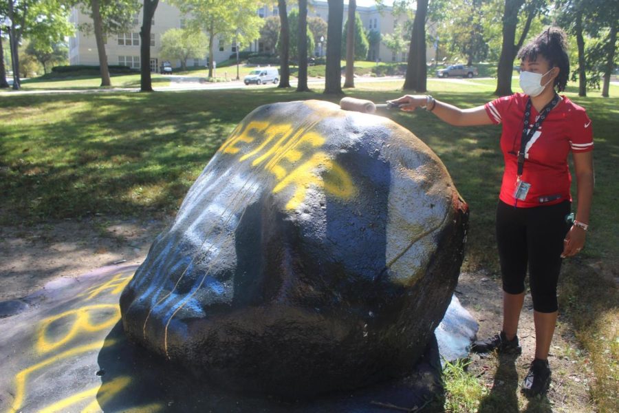 Director of Political Affairs and Grievances for B.U.S. Gabrielle Blake paints the rock Monday, Aug. 31. 