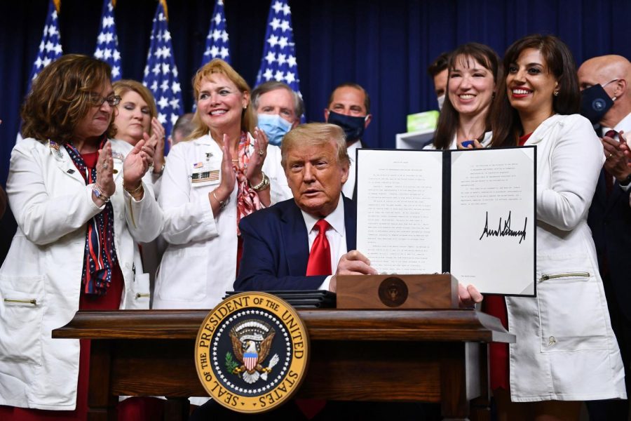 US+President+Donald+Trump+signs+an+executive+order+on+lowering+drug+prices+at+the+White+House%2C+in+Washington%2C+DC+on+July+24.