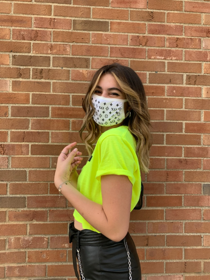 Katy Schormann, a sophomore fashion merchandise major at Kent State, models one of the 100 recruitment masks she designed for her sorority Chi Omega. She said the design was inspired by Louis Vuitton designs, but personalized for her own sorority.