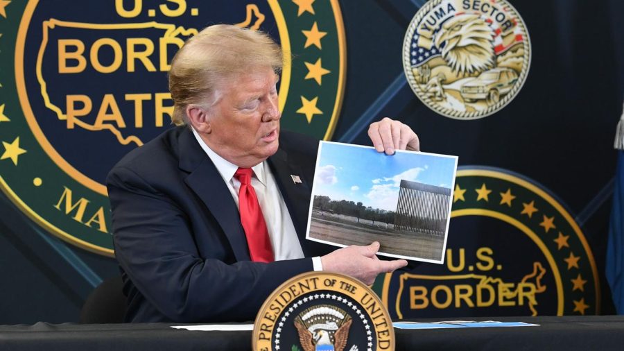 US+President+Donald+Trump+shows+a+photo+of+the+border+wall+upon+arrival+at+the+US+Border+Patrol+station+in+Yuma%2C+Arizona%2C+June+23%2C+2020.