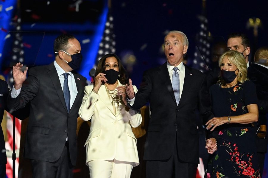 US+President-elect+Joe+Biden+and+Vice+President-elect+Kamala+Harris+react+as+confetti+falls%2C+with+Jill+Biden+and+Douglas+Emhoff%2C+after+delivering+remarks+in+Wilmington%2C+Delaware%2C+on+Nov.+7.