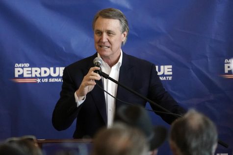 Republican candidate for Senate Sen. David Perdue speaks during a campaign stop at Peachtree Dekalb Airport Monday, Nov. 2, 2020, in Atlanta. The outcome in several contested states will determine whether Joe Biden defeats President Donald Trump. But if the Democratic challenger wins, the ambitions of a Biden presidency could well come down to Georgia. (AP Photo/John Bazemore)