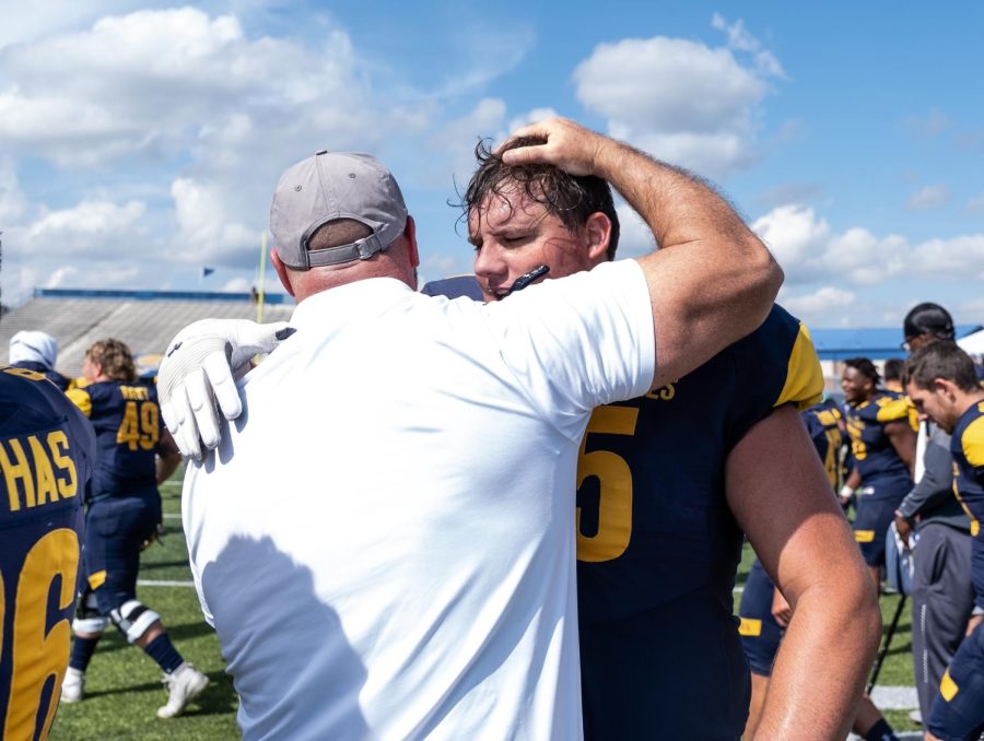 Junior+offensive+lineman+Adam+Gregoire+hugs+his+coach+after+Kent+State+beat+Kennesaw+State+University+26-23+in+overtime.+Saturday%2C+September+7%2C+2019.