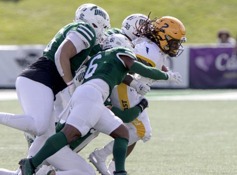 Senior running back Will Matthews is tackled during Kent States game at Ohio University on Saturday, Oct. 19, 2019.