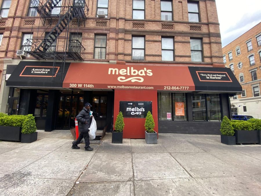 A person walks by Melbas restaurant in Harlem during the coronavirus pandemic on April 23, 2020 in New York City. COVID-19 has spread to most countries around the world, claiming over 189,000 lives with infections over 2.7 million people. 