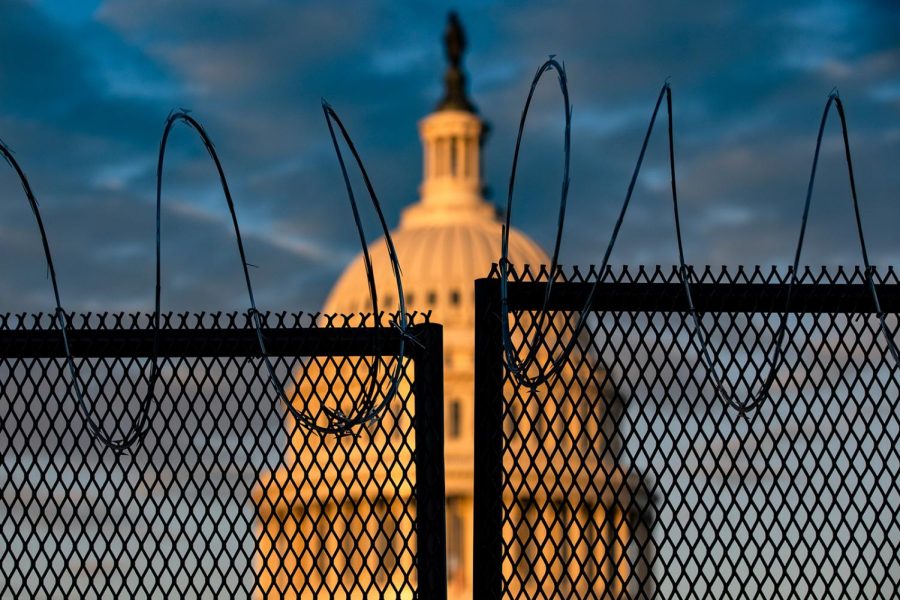 WASHINGTON, DC - JANUARY 16: The U.S. Capitol is seen behind a fence with razor wire during sunrise on January 16, 2021 in Washington, DC. After last weeks riots at the U.S. Capitol Building, the FBI has warned of additional threats in the nations capital and in all 50 states. According to reports, as many as 25,000 National Guard soldiers will be guarding the city as preparations are made for the inauguration of Joe Biden as the 46th U.S. President. (Photo by Samuel Corum/Getty Images)